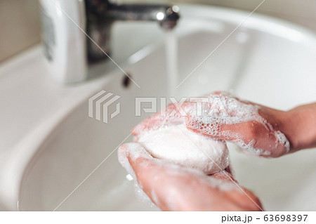 Man washing hands to protect against the coronavirus 63698397