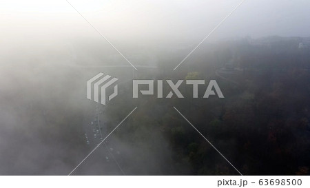 A city covered in fog. City traffic, aerial view A city covered in fog. City traffic, aerial view 63698500