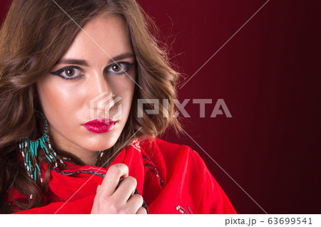 Woman in red sari Woman in red sari 63699541