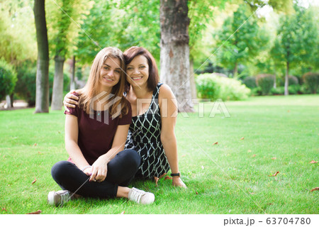 Cute young daughter embracing her mother with love. 63704780