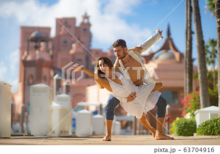 Young happy couple dancing in the summer park 63704916