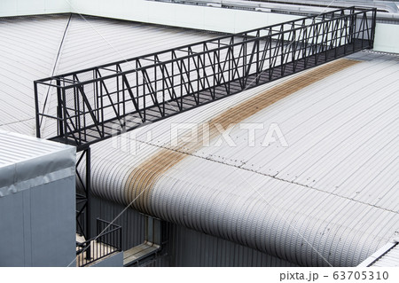 The black metal bridge is crossing the warehouse 63705310