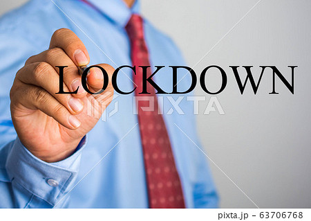 Businessman writing LOCKDOWN on virtual screen 63706768