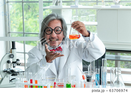 Senior male supervisor doing experiments and Senior male supervisor doing experiments and 63706974
