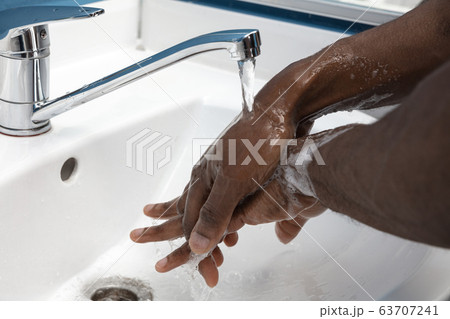 Man washing hands carefully in bathroom close up. Prevention of infection and pneumonia virus spreading 63707241