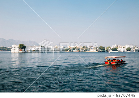 Taj Lake Palace and red boat at Pichola lake in Udaipur, India 63707448