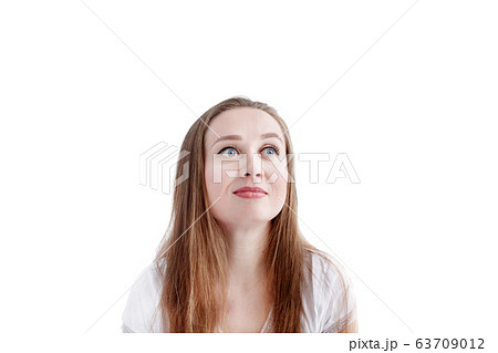 Close-up headshot of young natural pensive woman 63709012