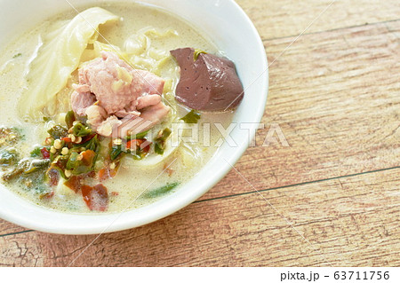 spicy boiled chicken meat and blood with slice cabbage in coconut milk soup on bowl spicy boiled chicken meat and blood with slice cabbage in coconut milk soup on bowl 63711756