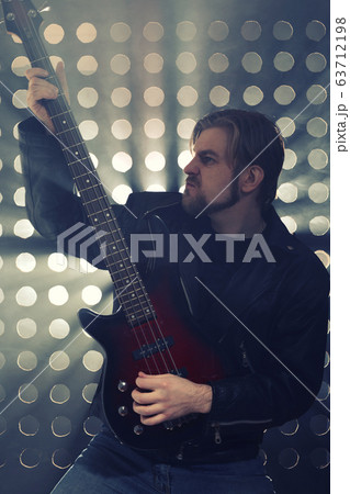 Bassist playing bass guitar in smoke. backlight Bassist playing bass guitar in smoke. backlight 63712198