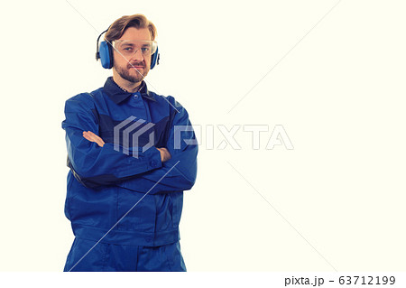 worker in safety glasses and headphones stands worker in safety glasses and headphones stands 63712199