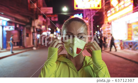 Woman close up look caucasian at Pattaya Walking Street with wearing protective medical mask. Lockdown quarantine isolation. Coronavirus covid-19. 63712307