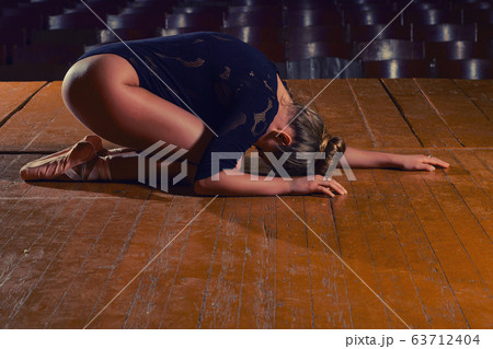 Professional ballet dancer lying on the stage Professional ballet dancer lying on the stage 63712404