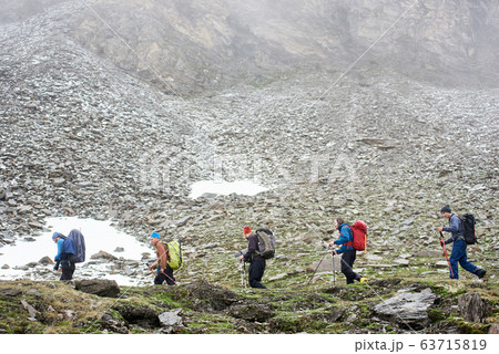 Male hikers walking on mountain path. Male hikers walking on mountain path. 63715819