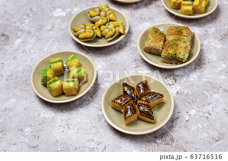 Traditional oriental sweets with different nuts on concrete background, top view, copy space 63716516