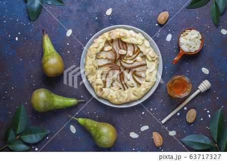 Homemade pear galette pie with almond leaves and fresh ripe green pears Homemade pear galette pie with almond leaves and fresh ripe green pears 63717327