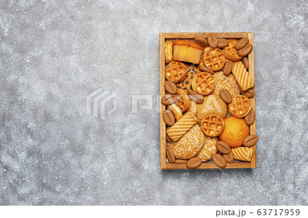 Various cookies in a wooden tray on gray background Various cookies in a wooden tray on gray background 63717959