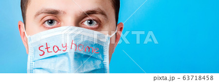 Portrait of young man in protective mask with Stay 63718458