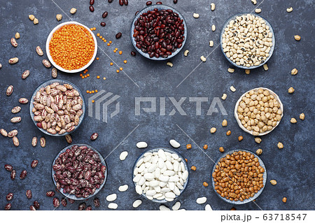 Legumes and beans assortment in different bowls on light stone background . Top view. Healthy vegan protein food. 63718547