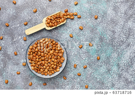 Legumes and beans assortment in different bowls on light stone background . Top view. Healthy vegan protein food. Legumes and beans assortment in different bowls on light stone background . Top view. Healthy vegan protein food. 63718716