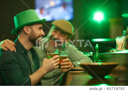 Men sitting at bar counter with beer Men sitting at bar counter with beer 63719792