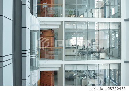 Several floors inside large business center with balconies, windows and offices 63720472