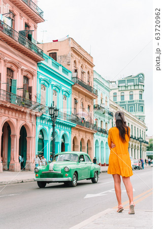 Tourist girls in popular area in Havana, Cuba. Young woman traveler smiling Tourist girls in popular area in Havana, Cuba. Young woman traveler smiling 63720962