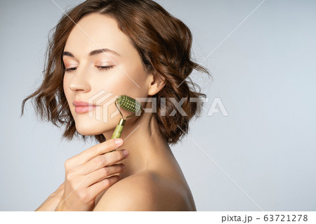 Close up of pretty girl that massaging her face Close up of pretty girl that massaging her face 63721278