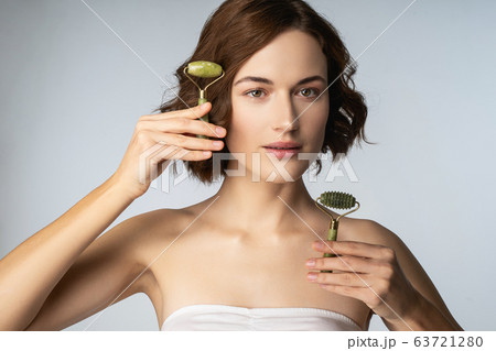 Beautiful brunette girl looking straight at camera Beautiful brunette girl looking straight at camera 63721280