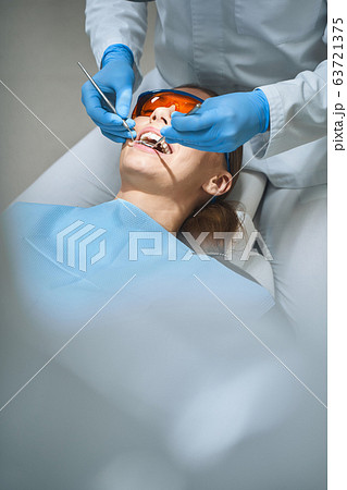 Dentist examoining patient in modern clinic stock photo 63721375