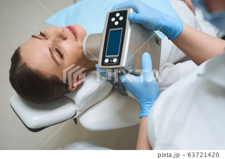 Relaxed woman during dental procedure stock photo Relaxed woman during dental procedure stock photo 63721420