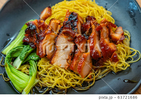 Plate of Chinese styled honey grilled pork belly noodles  63721686