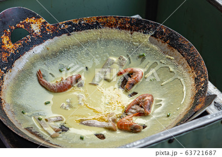 Cooking Vietnamese Banh Xeo shrimp crepe on the pan 63721687