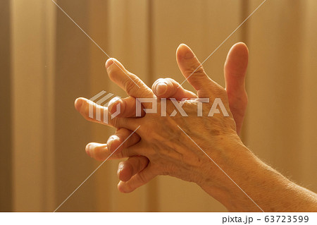 Older caucasian woman applying alcohol spray Older caucasian woman applying alcohol spray 63723599