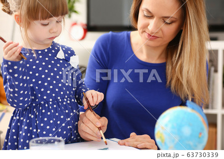 Blond smiling little girl hold in arm brush 63730339