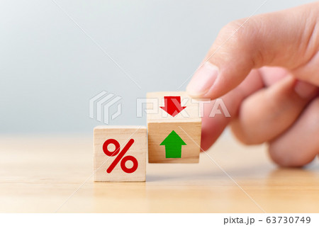 Interest rate financial and mortgage rates concept. Hand flip wood cube change arrow down to up Interest rate financial and mortgage rates concept. Hand flip wood cube change arrow down to up 63730749
