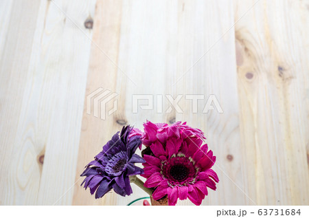 Beautiful artificial flowers on wooden background 63731684