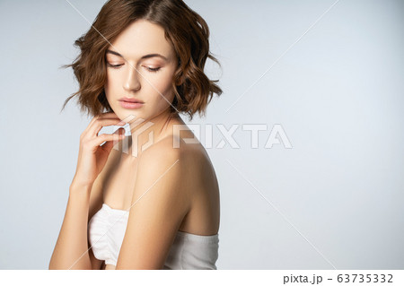 Portrait of tender woman that standing isolated on white 63735332
