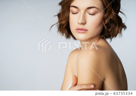 Relaxed young female person standing isolate on white 63735334