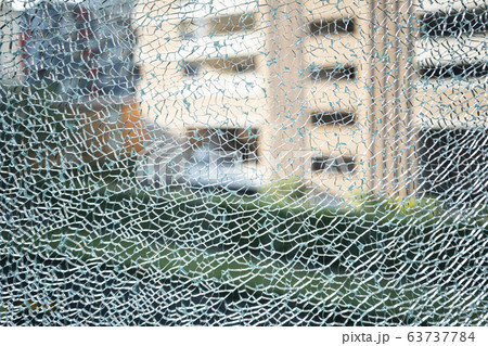 A cracked of blue green tempered glass 63737784