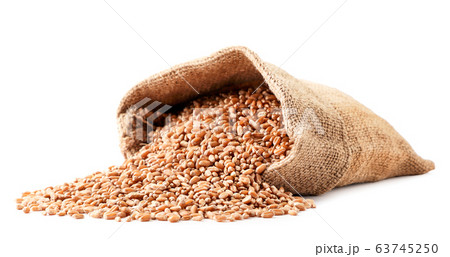 Grains of wheat spill out of the bag closeup on a 63745250