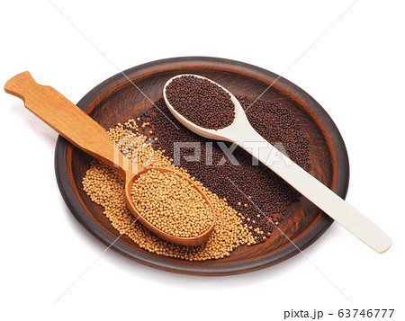 Mustard seeds black and white in a plate isolated on white 63746777