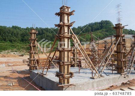 KUALA LUMPUR, MALAYSIA -MARCH 13, 2020: Column timber form work and reinforcement bar at the construction site. Installed by construction workers. The structure supported by temporary wood support. KUALA LUMPUR, MALAYSIA -MARCH 13, 2020: Column timber form work and reinforcement bar at the construction site. Installed by construction workers. The structure supported by temporary wood support. 63748785