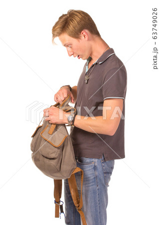 Young shocked student opening his backpack. 63749026