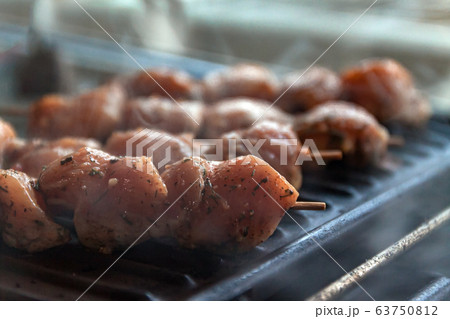 Skewers on skewers from raw meat of pork and beef, chicken cooked on a home electric grill. Top view 63750812