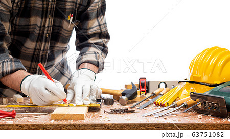 Carpenter at work on wooden boards. Carpentry. Carpenter at work on wooden boards. Carpentry. 63751082