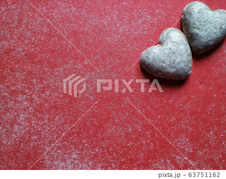 Red dusty background with heart shaped biscuits and text space for valentine's day Red dusty background with heart shaped biscuits and text space for valentine's day 63751162
