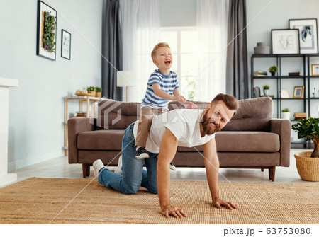 Father and little son having fun at home 63753080