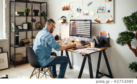 Modern designer working in home office Modern designer working in home office 63753085
