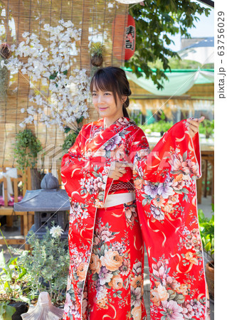 The girl is wearing a red traditional kimono, which is the national dress of Japan 63756029