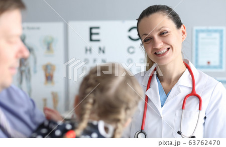 Doctor an optometrist conducts checks vision child Doctor an optometrist conducts checks vision child 63762470